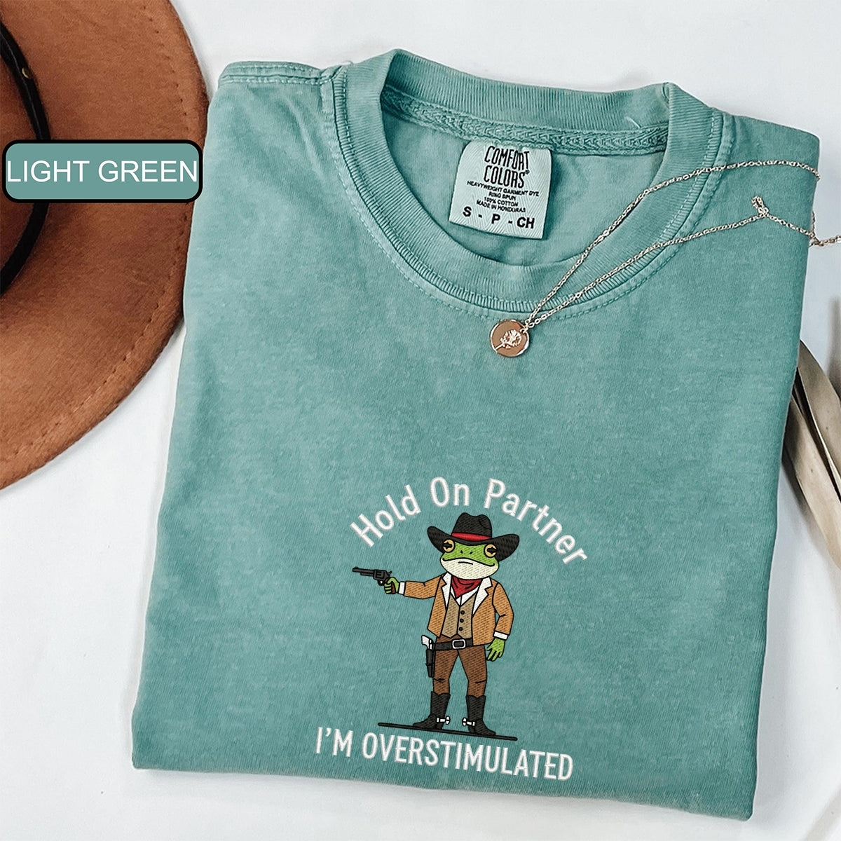 Custom Embroidered Hold On Partner, I’m Overstimulated T-Shirt | Cowboy Frog Meme Tee – Funny Anxiety Shirt Gift